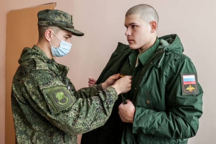 A young Russian conscript receives a military uniform ahead of departing for service in November 2021. (Kirill Kukhmar / TASS