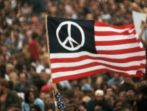 A peace sign printed on the American Flag is raised during a protest against the Vietnam War in Washington, D.C. (Photo: Archive / History Channel)